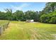 Picturesque lawn view with mature trees and fenced perimeter at 891 Wooten Ct, Canton, GA 30114