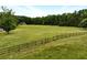 Scenic view of the property with a fenced pasture and house in the background at 891 Wooten Ct, Canton, GA 30114