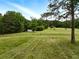 Scenic view of the property with a fenced pasture and house in the background at 891 Wooten Ct, Canton, GA 30114