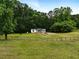 Home featuring fenced in yard, mature trees, screened porch and classic white siding, in private location at 891 Wooten Ct, Canton, GA 30114