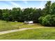 Home featuring fenced in yard, mature trees, screened porch and classic white siding, in private location at 891 Wooten Ct, Canton, GA 30114