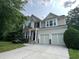 Inviting two-story home featuring a two-car garage and beautiful landscaping at 944 Reap Ln, Lawrenceville, GA 30043