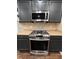 Close-up of modern stainless steel range and built-in microwave in kitchen at 944 Reap Ln, Lawrenceville, GA 30043