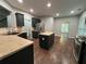Well-lit kitchen with a kitchen island, a stainless steel fridge and dark cabinets at 944 Reap Ln, Lawrenceville, GA 30043