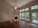 Bright living room features a fireplace, a ceiling fan and tall windows at 944 Reap Ln, Lawrenceville, GA 30043