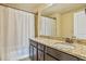A well-appointed bathroom has a vanity with granite countertop and a shower-tub combo at 11686 Davenport Ln, Alpharetta, GA 30005