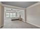 This bright bedroom boasts large windows, plush carpet, and a tray ceiling with modern ceiling fan at 11686 Davenport Ln, Alpharetta, GA 30005