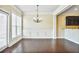 Dining room with hardwood floors, white trim, and chandelier at 11686 Davenport Ln, Alpharetta, GA 30005