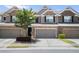 Brick townhouse with a two car garage and a well maintained front yard at 11686 Davenport Ln, Alpharetta, GA 30005