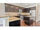 Well-equipped kitchen with stainless steel appliances, dark wood cabinets and island at 11686 Davenport Ln, Alpharetta, GA 30005