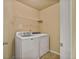 A functional laundry room is equipped with a washer, dryer, and wire shelving for storage at 11686 Davenport Ln, Alpharetta, GA 30005
