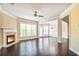 A well-lit living room with hardwood floors, a fireplace, and access to a dining room at 11686 Davenport Ln, Alpharetta, GA 30005