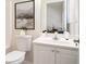 Well-lit bathroom featuring white cabinets, a toilet, and a stylish mirror at 3068 Lauren Parc Rd, Decatur, GA 30032
