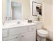 Bright bathroom featuring a white vanity with framed mirror, and white floral arrangement at 3068 Lauren Parc Rd, Decatur, GA 30032
