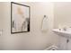Bright half-bathroom with a pedestal sink and modern artwork adding a touch of elegance at 3068 Lauren Parc Rd, Decatur, GA 30032