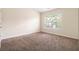 Bedroom with plush carpet, window, and neutral paint at 3068 Lauren Parc Rd, Decatur, GA 30032