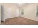 Bedroom featuring a ceiling fan, plush carpet, two closets, and a window at 3068 Lauren Parc Rd, Decatur, GA 30032