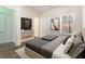 Comfortable bedroom with a large window, neutral colors, and a TV on a modern console at 3068 Lauren Parc Rd, Decatur, GA 30032