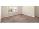 Bedroom with neutral walls, plush carpet, and large window at 3068 Lauren Parc Rd, Decatur, GA 30032