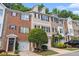Attractive townhomes with brick and siding exteriors, attached garages, and well-maintained lawns at 3068 Lauren Parc Rd, Decatur, GA 30032