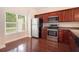 Kitchen with stainless steel appliances, wood cabinets, and ample natural light at 3068 Lauren Parc Rd, Decatur, GA 30032