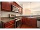 Kitchen with wood cabinets, stainless steel appliances, and a view to another room at 3068 Lauren Parc Rd, Decatur, GA 30032
