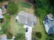 Aerial view of the home showing the roof, driveway, and surrounding trees at 455 Saddle Bow Dr, Lawrenceville, GA 30046