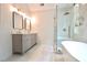 Bright bathroom featuring a double vanity, walk-in shower, and a modern aesthetic at 455 Saddle Bow Dr, Lawrenceville, GA 30046