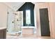 Elegant bathroom featuring a freestanding tub, glass-enclosed shower, and stylish finishes at 455 Saddle Bow Dr, Lawrenceville, GA 30046