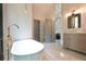 Modern bathroom features a freestanding tub, glass shower, and stylish vanity at 455 Saddle Bow Dr, Lawrenceville, GA 30046