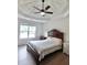 Bedroom with a coffered ceiling, ceiling fan, wood flooring, and traditional furniture at 455 Saddle Bow Dr, Lawrenceville, GA 30046