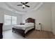 Bedroom with wood flooring, traditional bed frame, and a coffered ceiling with fan at 455 Saddle Bow Dr, Lawrenceville, GA 30046