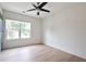 Bright, empty bedroom showcasing natural light, neutral paint, and hardwood flooring at 455 Saddle Bow Dr, Lawrenceville, GA 30046