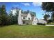 A charming two-story white home with a large lawn and attached garage at 455 Saddle Bow Dr, Lawrenceville, GA 30046