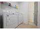 Well-equipped laundry room with modern washer, dryer, and shelving at 455 Saddle Bow Dr, Lawrenceville, GA 30046
