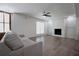 Cozy living room featuring a fireplace, ceiling fan, and neutral decor at 455 Saddle Bow Dr, Lawrenceville, GA 30046