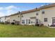 Townhome backyard with well-kept grass and a small patio area with outdoor furniture at 2924 Greyhawk Ln, Cumming, GA 30040