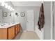 Bright bathroom featuring double sinks, a soaking tub, and a glass-enclosed shower at 2924 Greyhawk Ln, Cumming, GA 30040