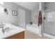 Bright bathroom featuring double sinks, a soaking tub, and a glass-enclosed shower at 2924 Greyhawk Ln, Cumming, GA 30040