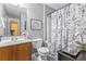 Bathroom featuring a shower/tub combo, granite counter top, framed art, and modern fixtures at 2924 Greyhawk Ln, Cumming, GA 30040