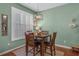 Intimate dining area with wood floors, natural light, and modern light fixture at 2924 Greyhawk Ln, Cumming, GA 30040