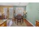 Cozy dining room with natural light, hardwood floors, and views into the kitchen at 2924 Greyhawk Ln, Cumming, GA 30040
