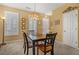 Inviting dining room featuring neutral paint, modern lighting and a dark wood dining table set for four at 2924 Greyhawk Ln, Cumming, GA 30040