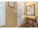 Bright entryway featuring a white door, decorative mirror, a table and umbrella holder atop a hardwood floor at 2924 Greyhawk Ln, Cumming, GA 30040