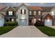 Charming townhome featuring a one car garage, red front door, manicured lawn, and inviting curb appeal at 2924 Greyhawk Ln, Cumming, GA 30040