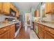 Well-lit kitchen features wood cabinets, stainless steel appliances, and durable floors at 2924 Greyhawk Ln, Cumming, GA 30040