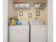 Laundry room with washer, dryer, wire rack shelving, and a variety of cleaning supplies at 2924 Greyhawk Ln, Cumming, GA 30040