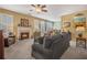 Cozy living room with neutral paint, a fireplace, plush seating, and bright windows creating a relaxing atmosphere at 2924 Greyhawk Ln, Cumming, GA 30040