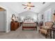 Spacious main bedroom featuring a vaulted ceiling, ceiling fan and complementing dark wood furniture at 2924 Greyhawk Ln, Cumming, GA 30040
