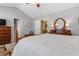 Spacious primary bedroom featuring neutral paint, large bed, and doorway to ensuite bath at 2924 Greyhawk Ln, Cumming, GA 30040